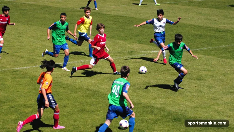 Diagram of a 9v9 youth soccer formation showing defenders, midfielders, and forwards on a smaller pitch