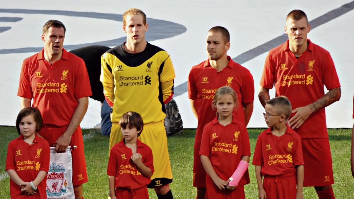 File photo from 25 July 2012: Jamie Carragher (left) with Liverpool team-mates at Fenway Park, Boston. It was not taken at a podcast recording and does not show the Aston Villa row.