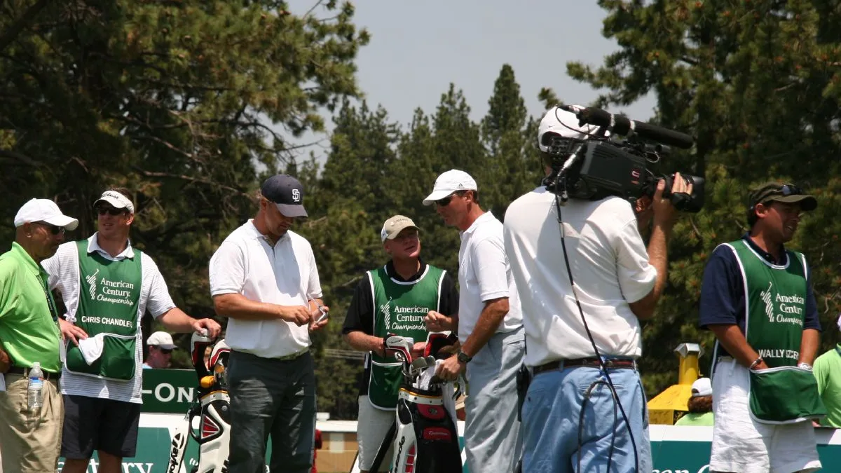 File photo from July 13, 2008: Mario Lemieux, wearing the white cap, at the American Century Championship celebrity golf event at Lake Tahoe, with Chris Chandler beside him. Mario is Austin Lemieux's father and a keen golfer himself. The photo is from 2008, shows Mario and not Austin, and does not show this week's Bermuda Championship. The cropped derivative is offered under the same CC BY-SA 2.0 licence.