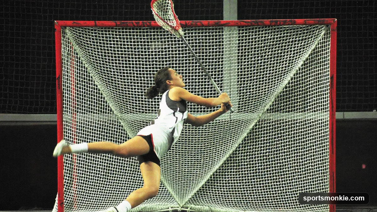 A lacrosse attacker firing a behind-the-back shot near the crease