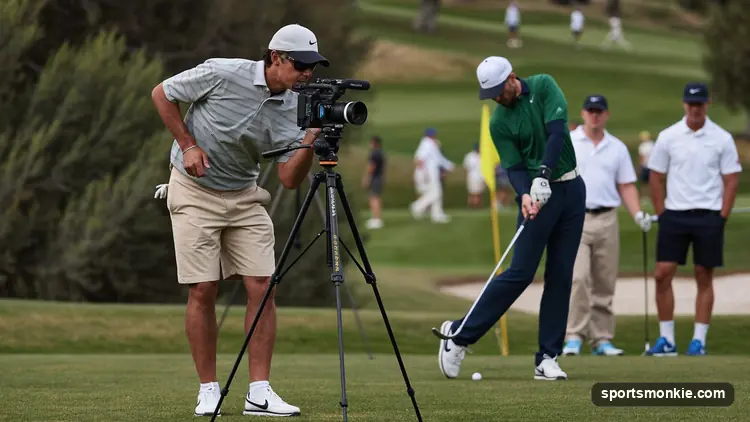 a golfer filming a swing with a camera on a tripod at the range