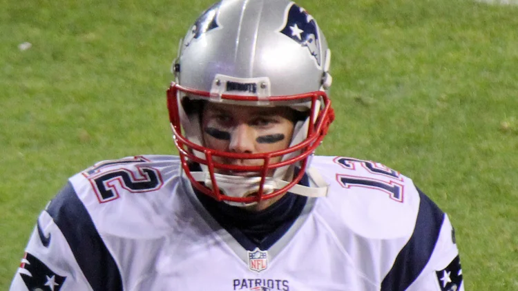 File photo from 29 November 2015: Tom Brady in his New England Patriots No. 12 jersey and silver helmet on the field in Denver. It was not taken at Sunday's Packers-Lions game, which Brady called from the FOX broadcast booth.