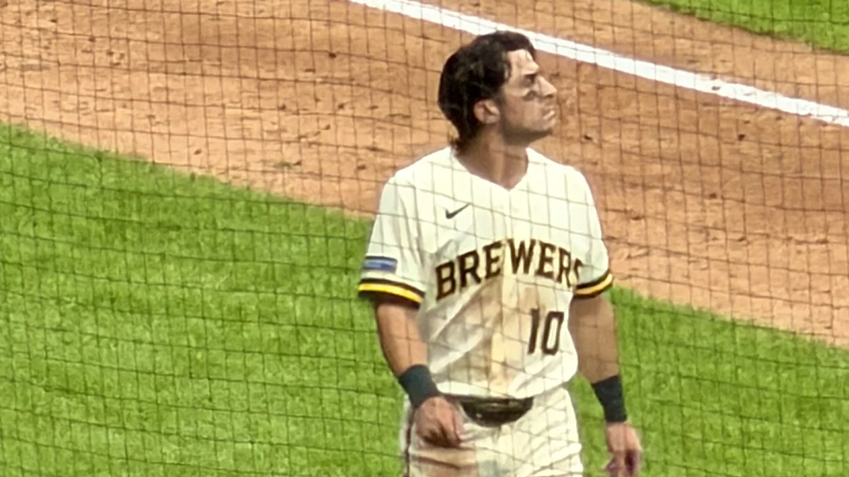 File photo from 12 October 2026: Sal Frelick walking near the Brewers dugout during Game 2 of the NLCS. It was not taken at Lambeau Field and does not show the trophy visit or the Lambeau Leap.