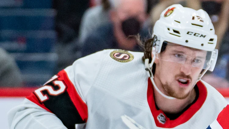 File photo from January 22, 2022: Ottawa Senators defenceman Thomas Chabot in a white road jersey at Washington. It predates his captaincy and does not show Saturday's game in Philadelphia. The 16:9 cropped derivative is offered under the same CC BY-SA 2.0 licence as the original.
