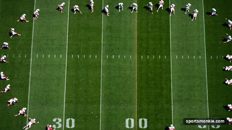 Diagram-style illustration of an NFL Cover 4 quarters defense with four deep defenders splitting the field into quarters and three linebackers underneath