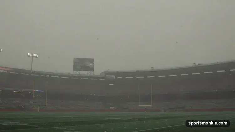 American football helmet resting on an empty field beneath a grey overcast sky