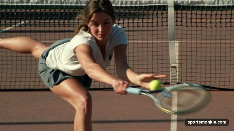 Tennis player hitting a delicate drop shot with an open racquet face just over the net