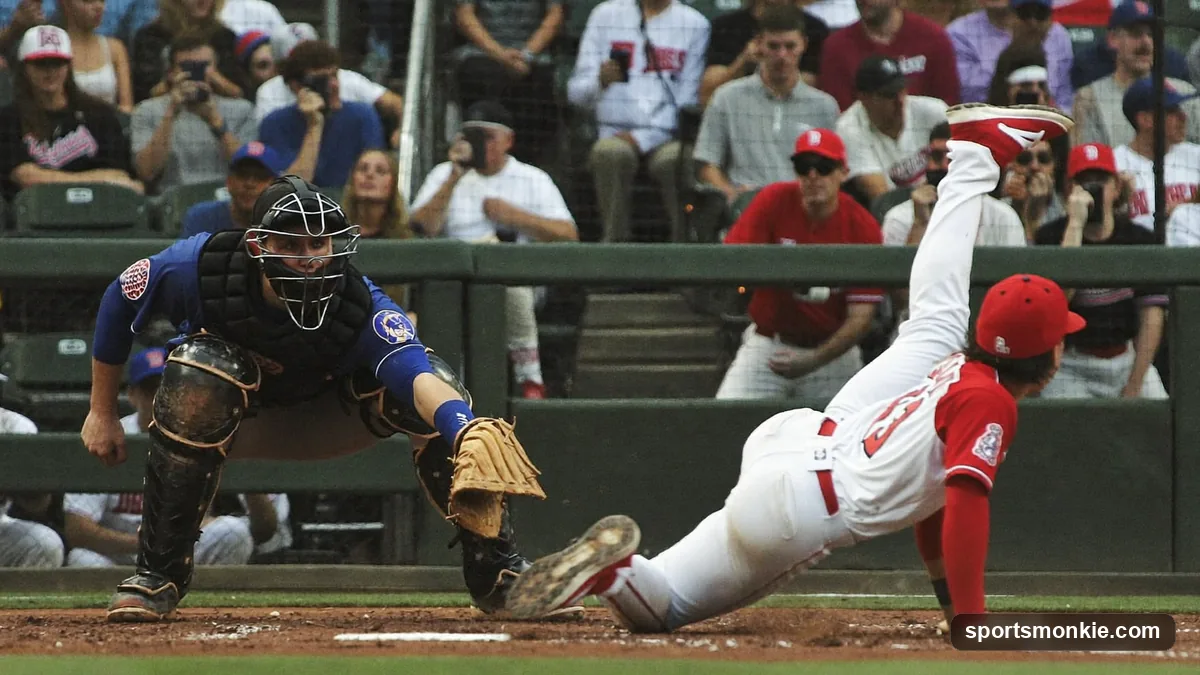A baseball catcher scrambling for a pitch in the dirt as the batter runs to first