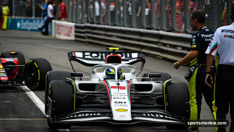An F1 car serving a penalty in the pit lane with stewards' timing equipment visible
