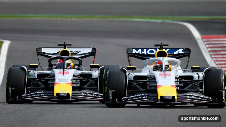 Two Formula 1 cars running nose to tail down a straight, the second in the slipstream of the first