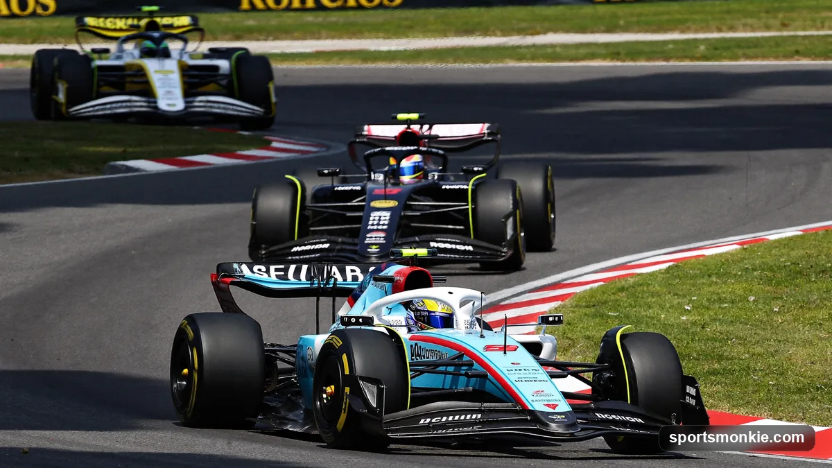 A pack of Formula 1 cars racing closely on the opening lap of a short Saturday sprint race