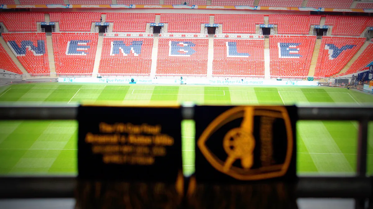 File photo from the 2015 FA Cup final: Wembley Stadium with the WEMBLEY lettering spelled out in the seats. It does not show the 2026-27 first round.