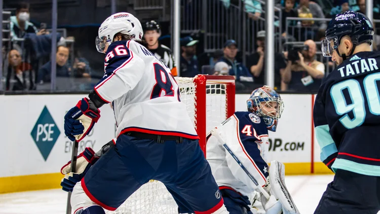 File photo from January 28, 2024: Kirill Marchenko in a Columbus Blue Jackets jersey, number 86, in front of the Seattle net, with Daniil Tarasov in goal behind him and Tomas Tatar at the right edge. It is a file photo from his Columbus years and does not show Tuesday's game in Columbus. The 16:9 cropped derivative is offered under the same CC BY-SA 2.0 licence as the original.