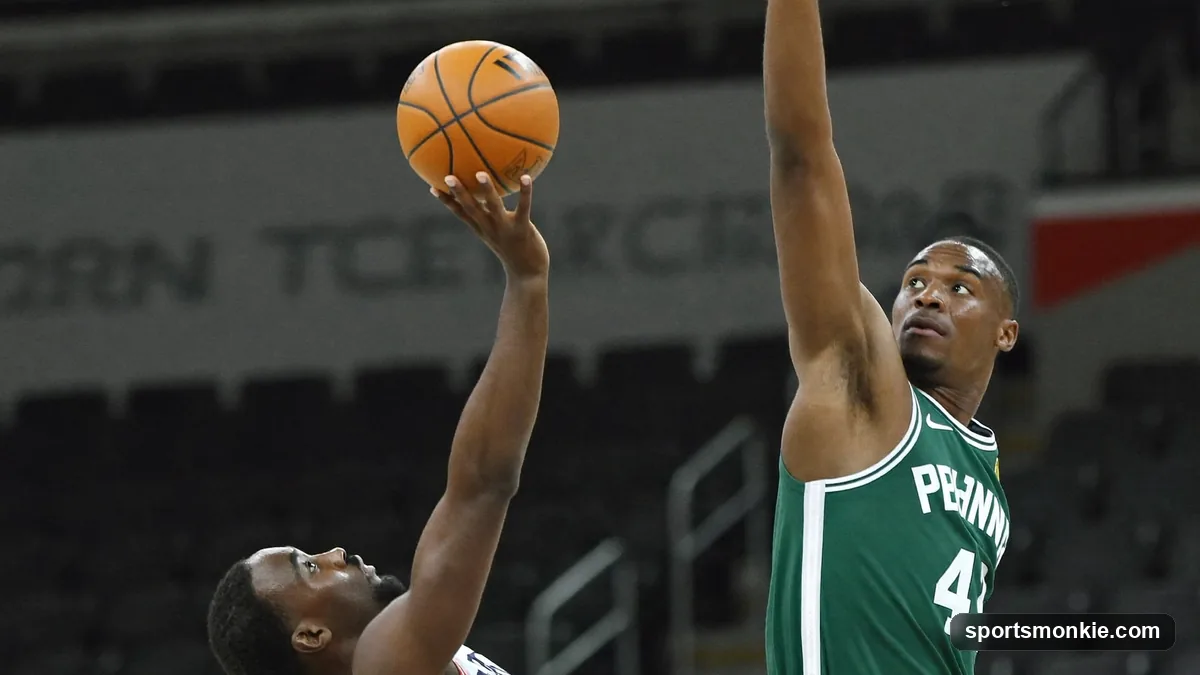 A basketball player releasing a finger roll shot off the fingertips near the rim