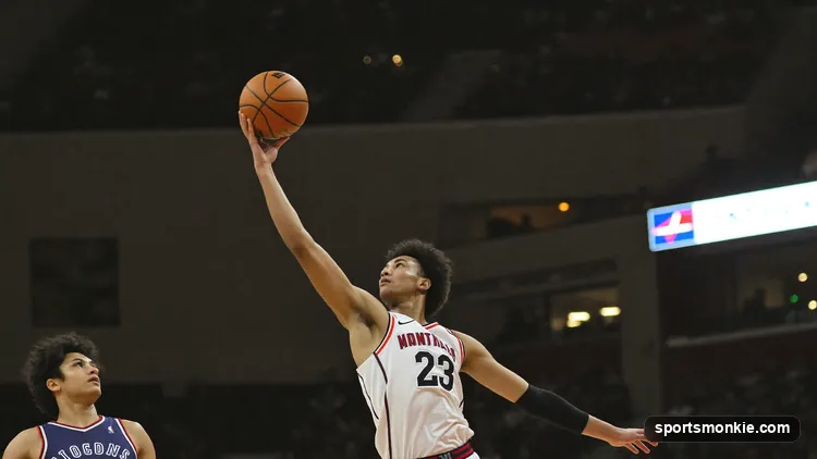 A basketball guard releasing a high-arcing floater shot over a taller defender in the lane
