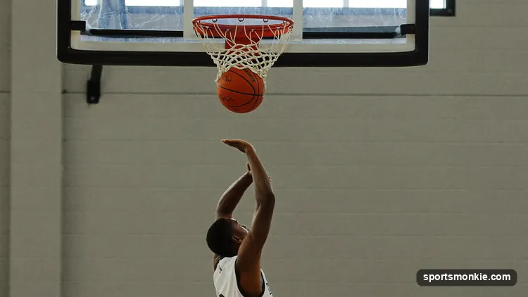 A basketball player at the free-throw line preparing to shoot