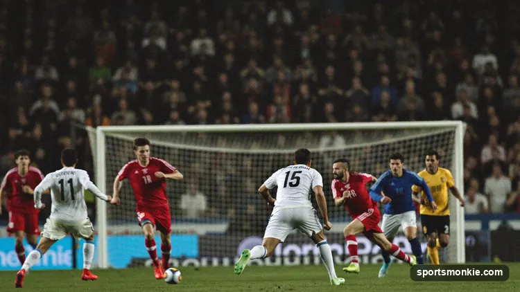 Soccer players pressing an opponent high up the pitch near the touchline to win back possession