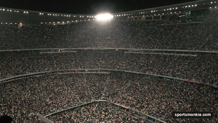 A vast packed grandstand filled with spectators at a major sporting event