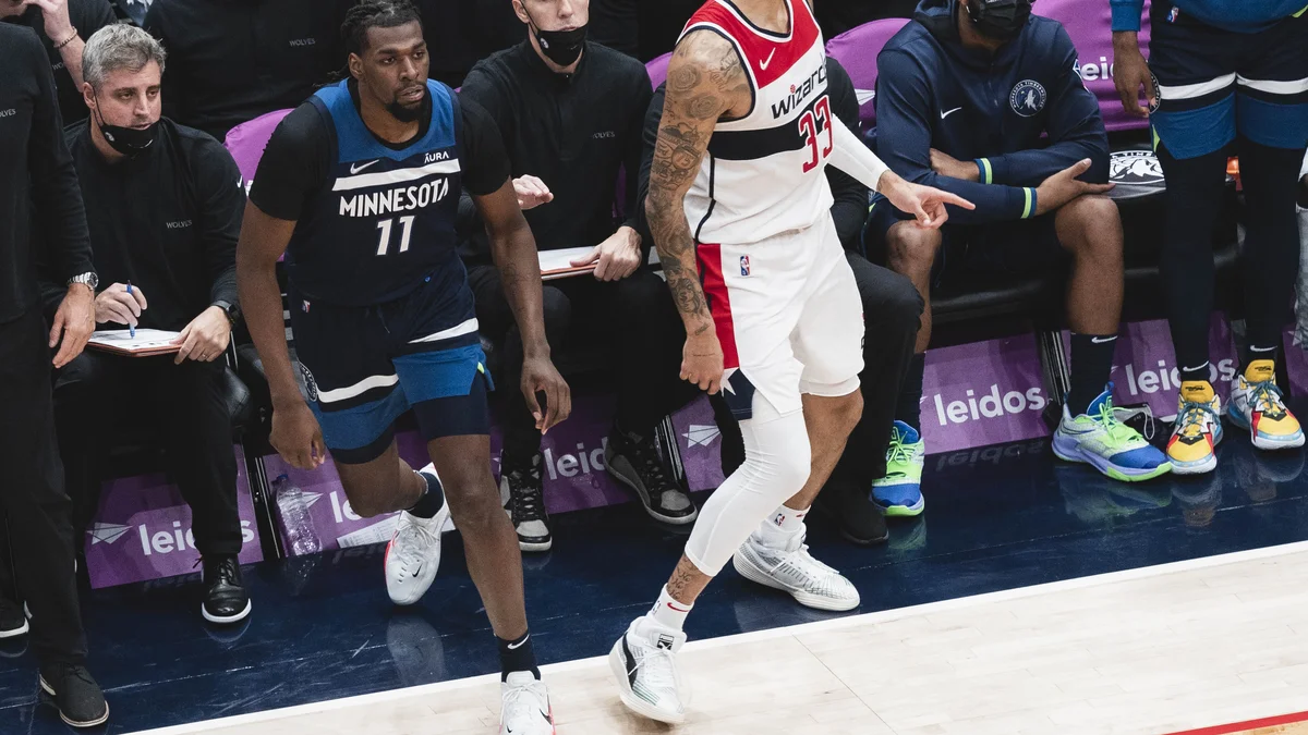 File photo from 1 December 2021: Naz Reid, in Minnesota's No. 11 jersey, walks past the Timberwolves bench during a game against Washington. It was not taken at the Detroit game and does not show the benching.
