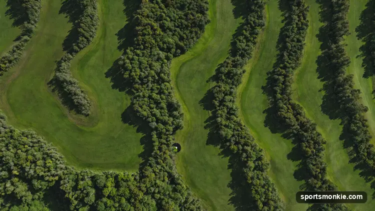 Aerial view of an 18-hole golf course showing fairways, greens and surrounding tree lines