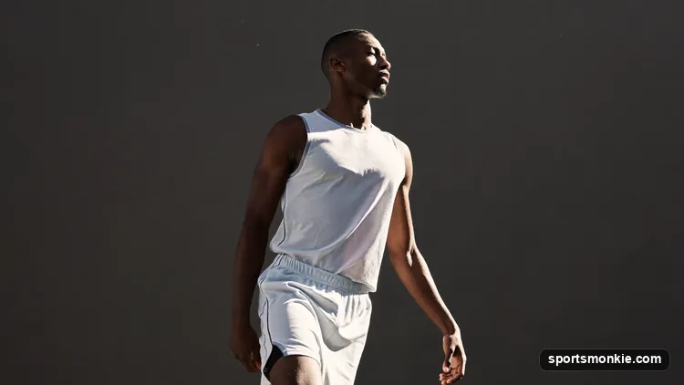 Player releasing a jump shot with high arc and locked follow-through wrist