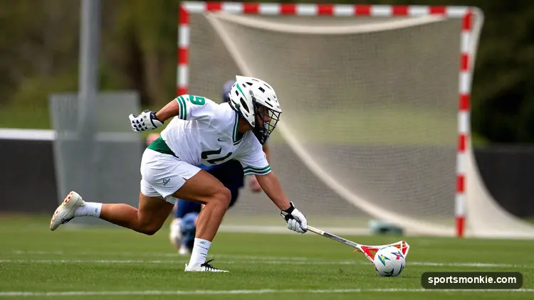 An attacker sprinting toward the endline to back up a shot as the ball rolls out of bounds