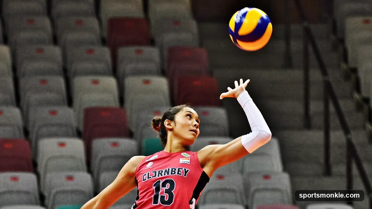 Volleyball libero in a contrasting jersey digging a low ball in the back row