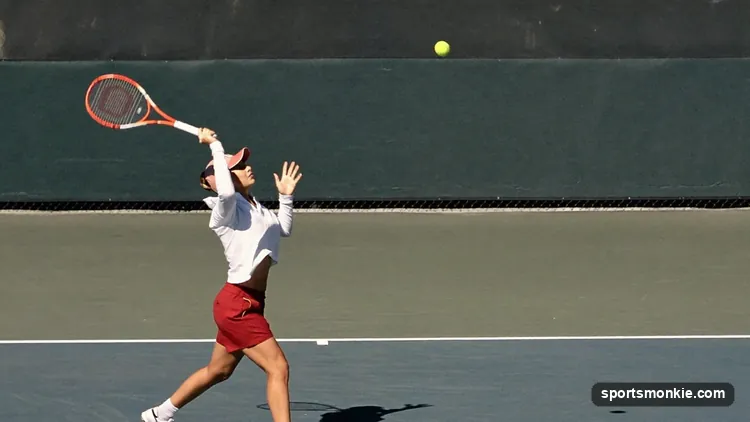 Tennis player hitting a high arcing lob shot over an opponent at the net