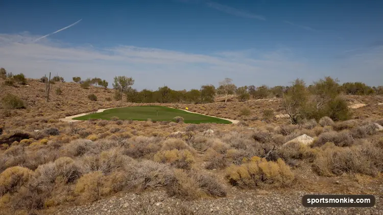 Remote outback golf hole with a rough fairway cutting through open desert scrub