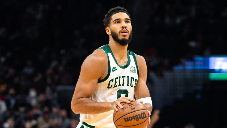 File photo of Jayson Tatum in a Celtics jersey holding a basketball. It was not taken at TD Garden on October 27 and does not show the buzzer-beater or the Nets game.