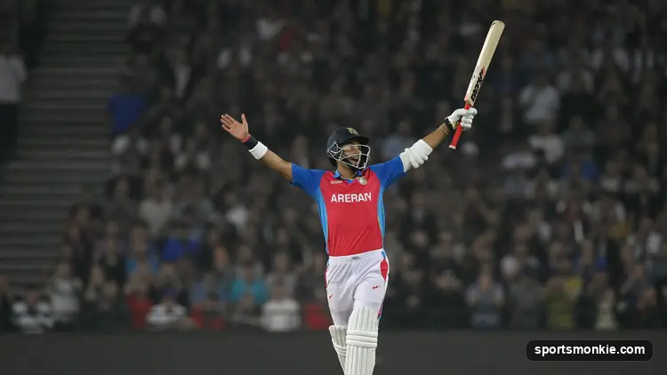 Batter removing the helmet and raising the bat to celebrate reaching a century