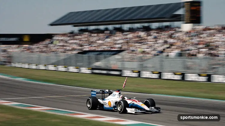 Formula 1 car crossing the finish line first as a checkered flag waves