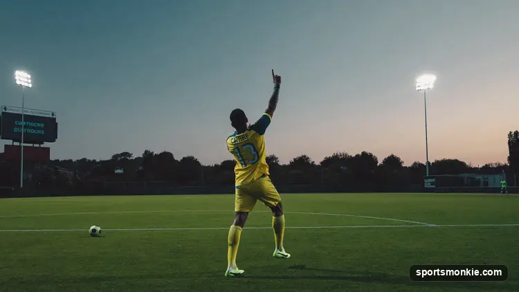Football resting on the penalty spot of a stadium pitch