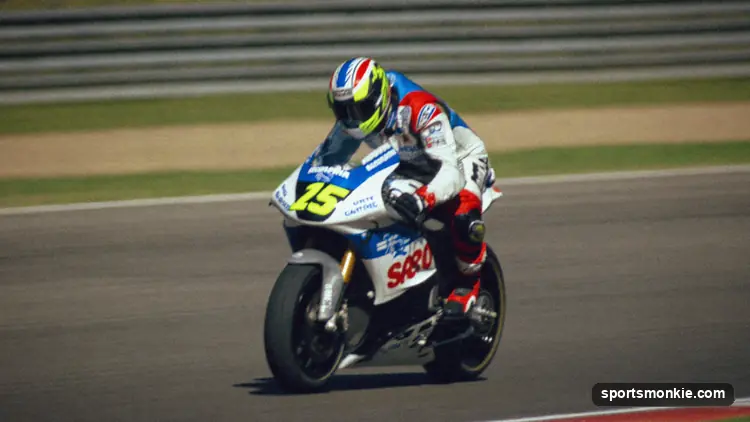 MotoGP rider leaning into a corner at high speed with knee to the tarmac