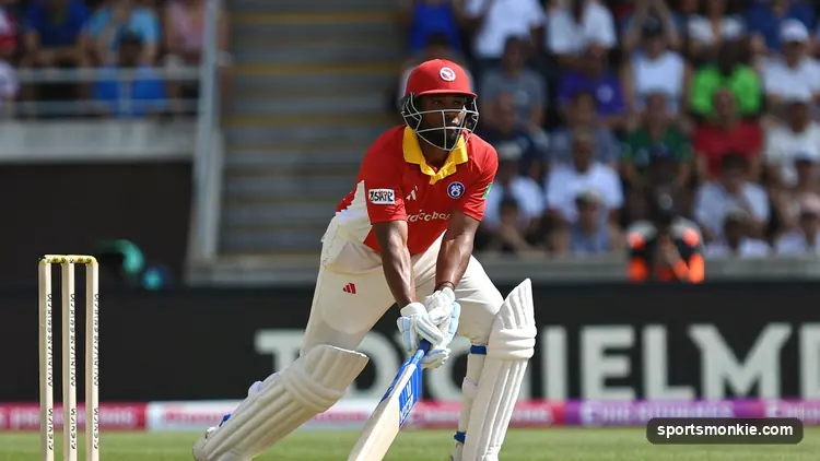 Batter raising the bat to acknowledge the crowd after a long innings