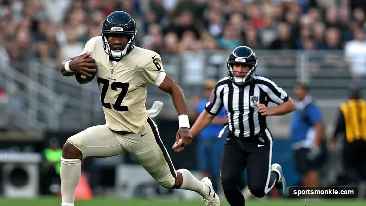 Quarterback breaking the pocket and running downfield past defenders