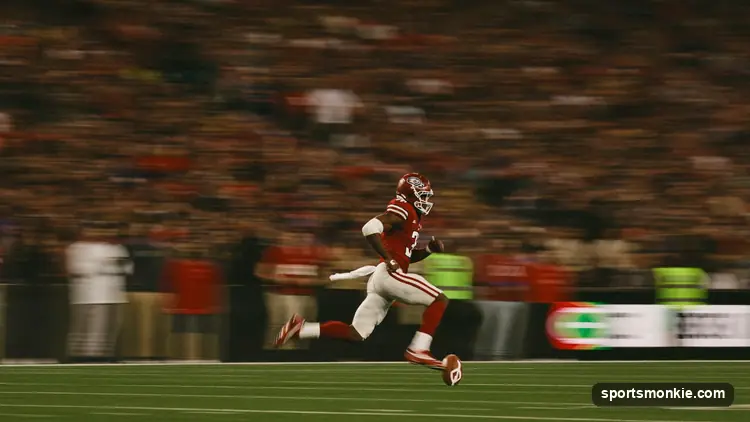 A running back bursting through the line of scrimmage under stadium lights