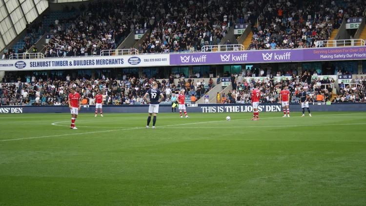 File photo from August 30, 2025: players on the pitch at The Den before Millwall played Wrexham. It does not show the Swansea match or the stoppage.