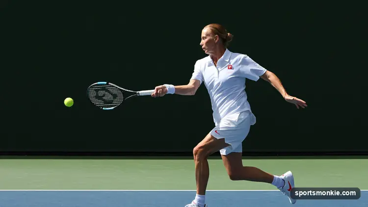 Tennis racket and ball on a clay court beside the baseline