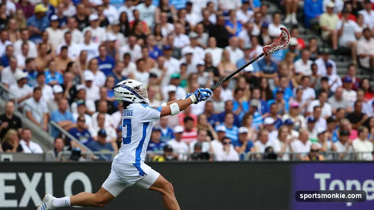 A lacrosse player shooting from behind the two-point arc in a pro game