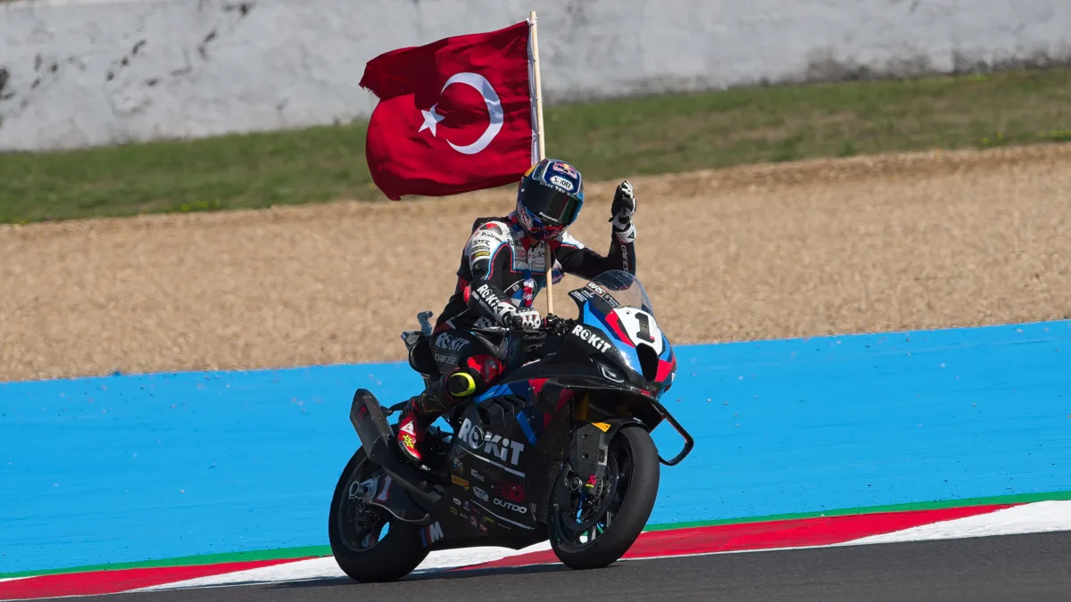File photo from 7 September 2025 of Toprak Razgatlioglu on his lap of honour at the French round of the World Superbike Championship, carrying a Turkish flag. It is a file photo from his Superbike season and does not show the Indonesian Grand Prix, the crash or his MotoGP bike. The cropped derivative is offered under the same CC BY-SA 4.0 licence.