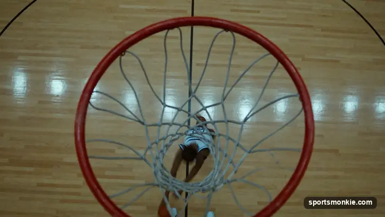The painted restricted-area arc under a basketball hoop with players driving to the rim