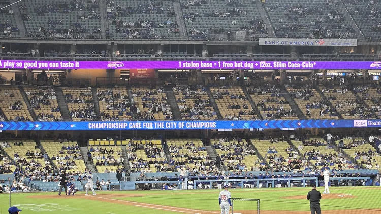File photo from 12 April 2025: Miguel Rojas pitching in relief for the Dodgers against the Cubs at Dodger Stadium. It does not show the 2026 NLCS. The 16:9 cropped derivative is offered under the same CC BY-SA 4.0 licence.