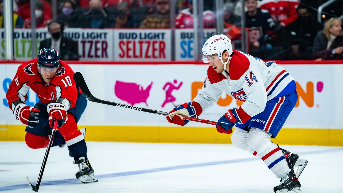 File photo from November 24, 2021: Nick Suzuki in the Canadiens' white No. 14 jersey during a game against Washington at Capital One Arena. It is a file photo from 2021 and does not show Tuesday's game against San Jose or the injury. The cropped derivative is offered under the same CC BY-SA 2.0 licence.
