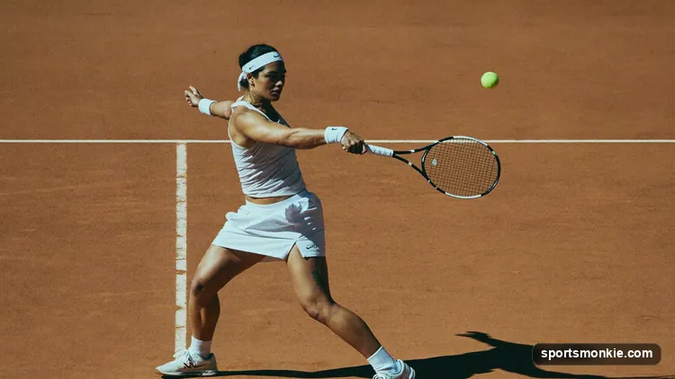 Tennis player hitting a backhand groundstroke on a hard court