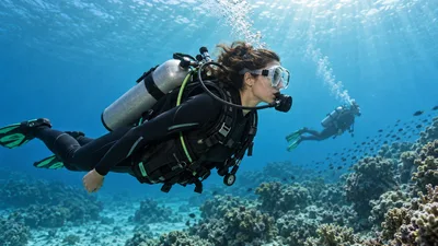Illustration of a scuba diver carrying a cylinder and breathing through a regulator above a reef, with a buddy behind