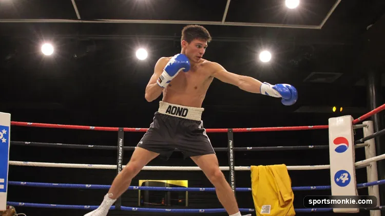 A referee waving off a boxing match as a fighter falls to the canvas