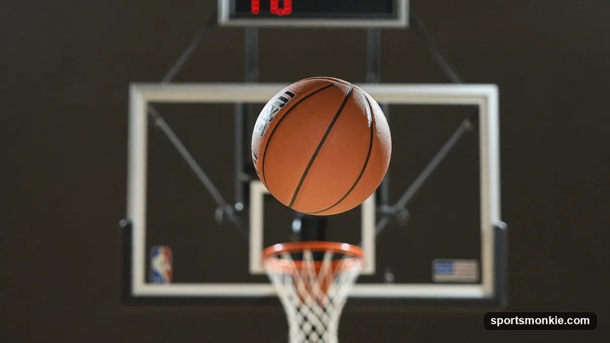 A basketball player launching a shot toward the hoop in an indoor gym