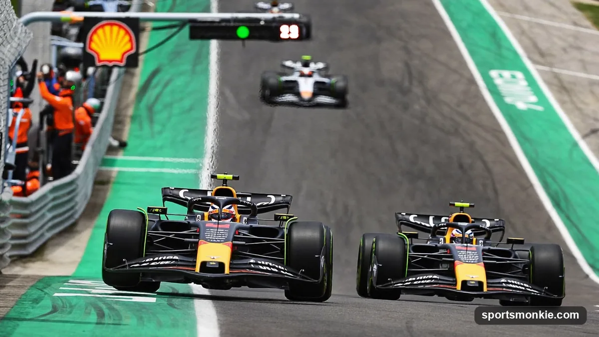A Formula 1 car entering the pit lane while a rival stays out on track, illustrating pit strategy