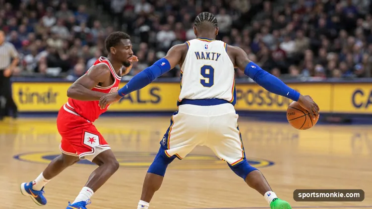 Basketball defender taking a charge as an offensive player drives into him under the basket